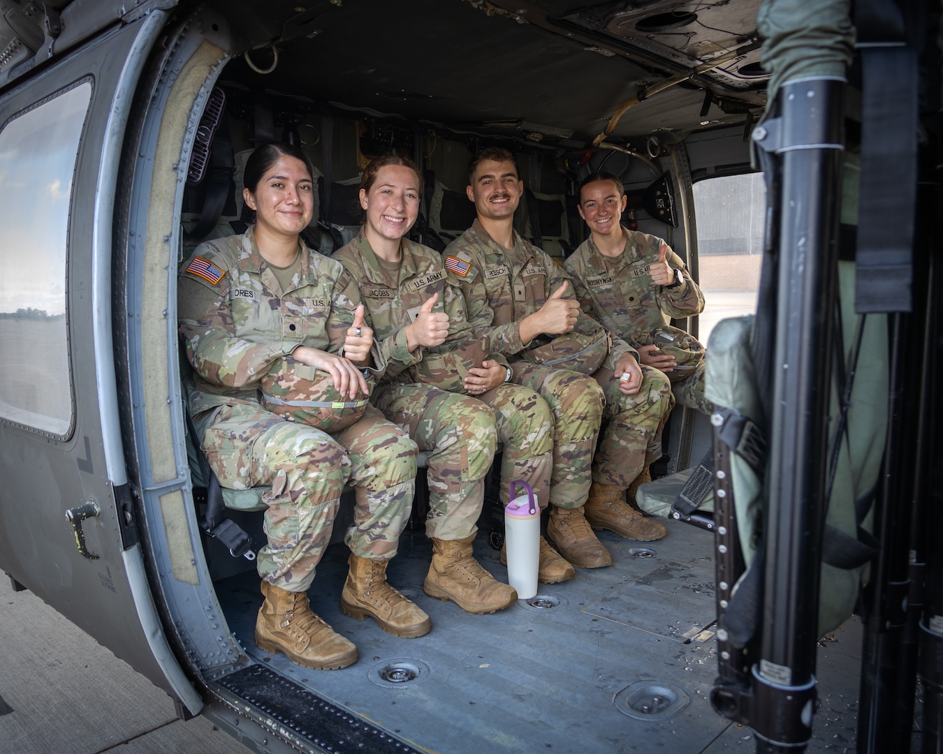 FORT RILEY, Kan. — Army ROTC nursing cadets (left to right) Perla Flores Aguirre, Kasey Jacobs, Jack Rebsch, Claire Troshynski wait inside the cabin of a UH-60 Blackhawk helicopter moments before take-off at Marshall Army Airfield, July 31. The familiarization flight over the Flint Hills of Kansas concluded an airfield tour designed to expose the future Army Nurse Corps officers to tactical medical evacuation platforms. The operational training event was part of their four-week Nurse Summer Training Program (NSTP) clinical rotation at Irwin Army Community Hospital.