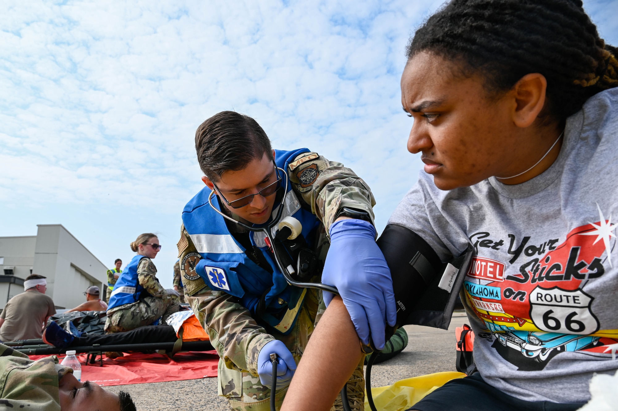 An Airman checks a person blood pressure.