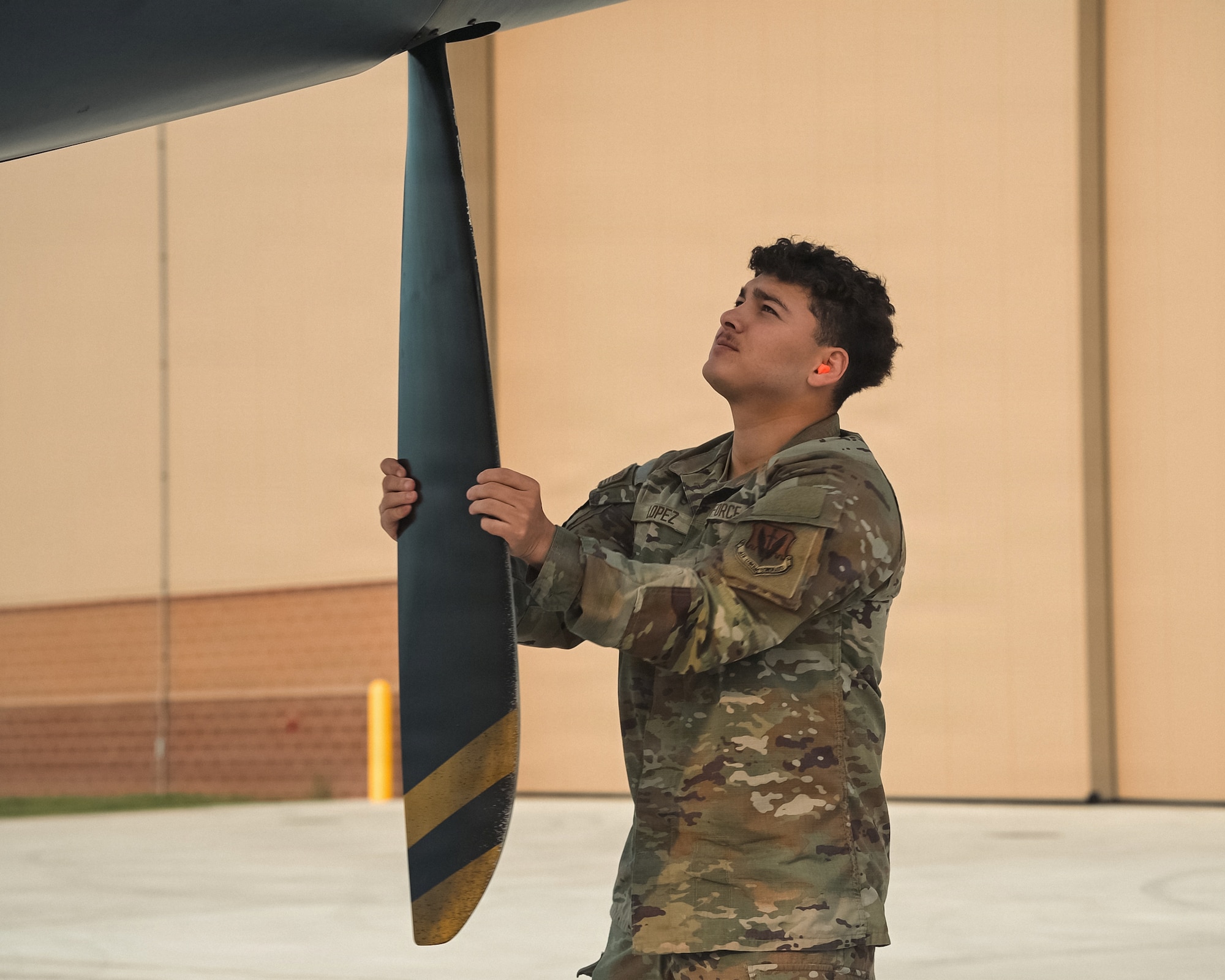 U.S. Air Force Airman Kevin Lopez, 29th Aircraft Maintenance Unit support technician, checks the propellers of an MQ-9 Reaper at Alpena Combat Readiness Training Center, Michigan, July 20, 2026