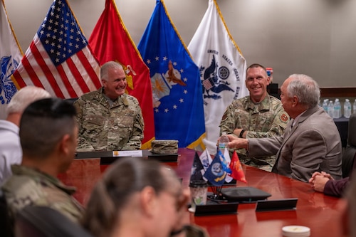 Both uniformed personnel and Texas legislators sit and discuss at a roundtable.