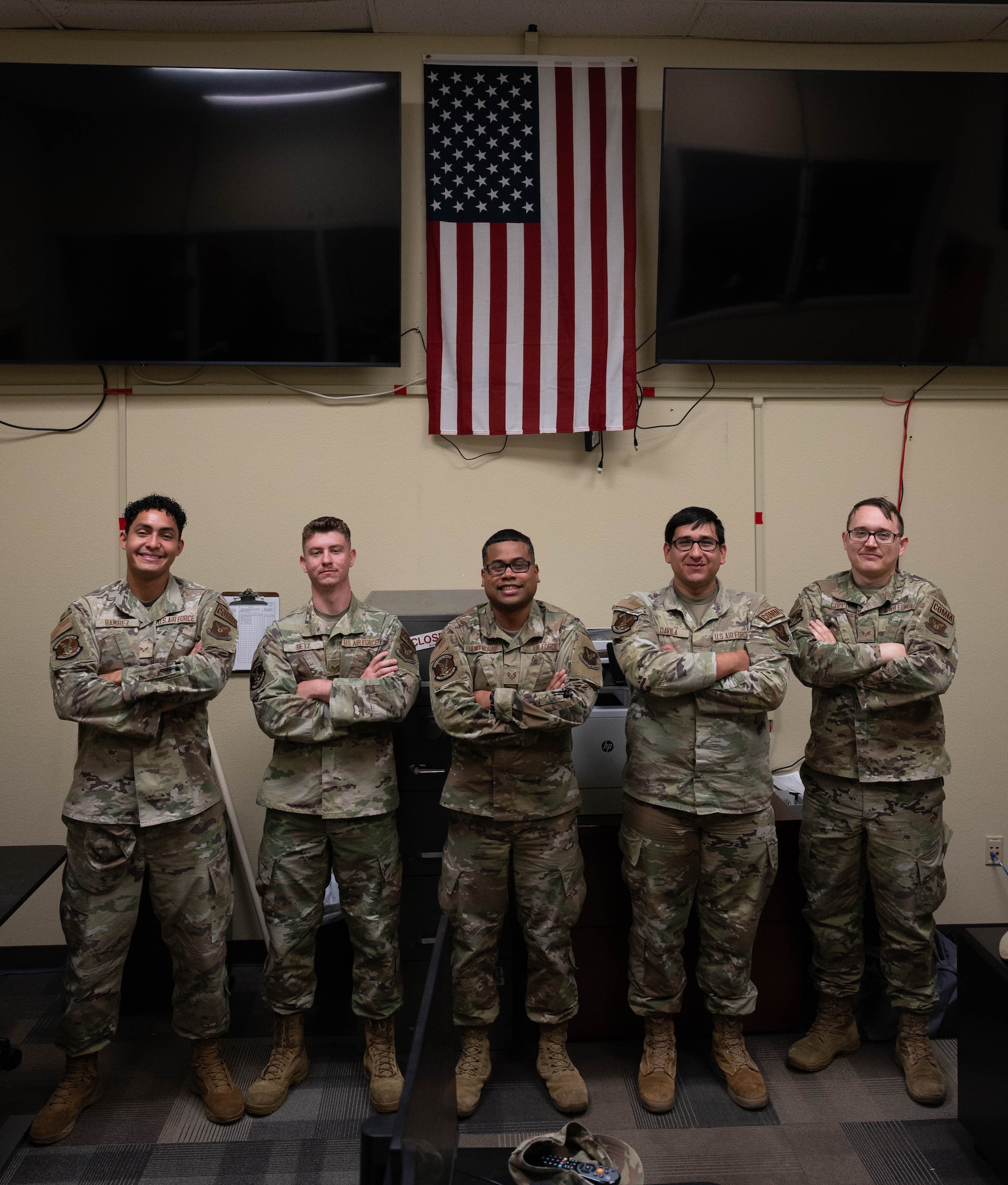 U.S. Airmen with the 5th Communications Squadron (5th CS) Communications Focal Point (CFP) work center pose for a photo at Minot Air Force Base, North Dakota, Aug. 5, 2026.