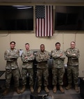 U.S. Airmen with the 5th Communications Squadron (5th CS) Communications Focal Point (CFP) work center pose for a photo at Minot Air Force Base, North Dakota, Aug. 5, 2026.