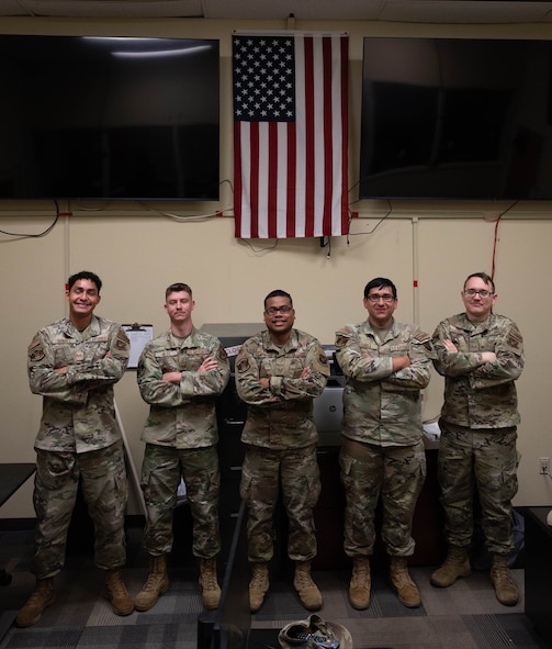 U.S. Airmen with the 5th Communications Squadron (5th CS) Communications Focal Point (CFP) work center pose for a photo at Minot Air Force Base, North Dakota, Aug. 5, 2026.