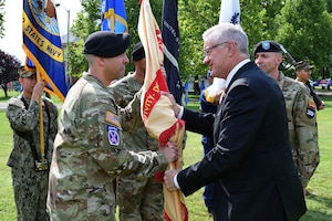 U.S. Army Col. Clay Huffman, left, U.S. Army Support Activity Fort Dix incoming commander, receives the USASA Fort Dix colors from Patrick J. Appelman, right, Installation Management Command - Western Hemisphere director, during the USASA Fort Dix change of command ceremony at Joint Base McGuire-Dix-Lakehurst, N.J., July 29, 2026. Appelman served as the reviewing official for the ceremony, during which, Huffman assumed command of USASA Fort Dix from U.S. Army Col. Bryan Dunker. (U.S. Air Force photo by Kris Patterson)