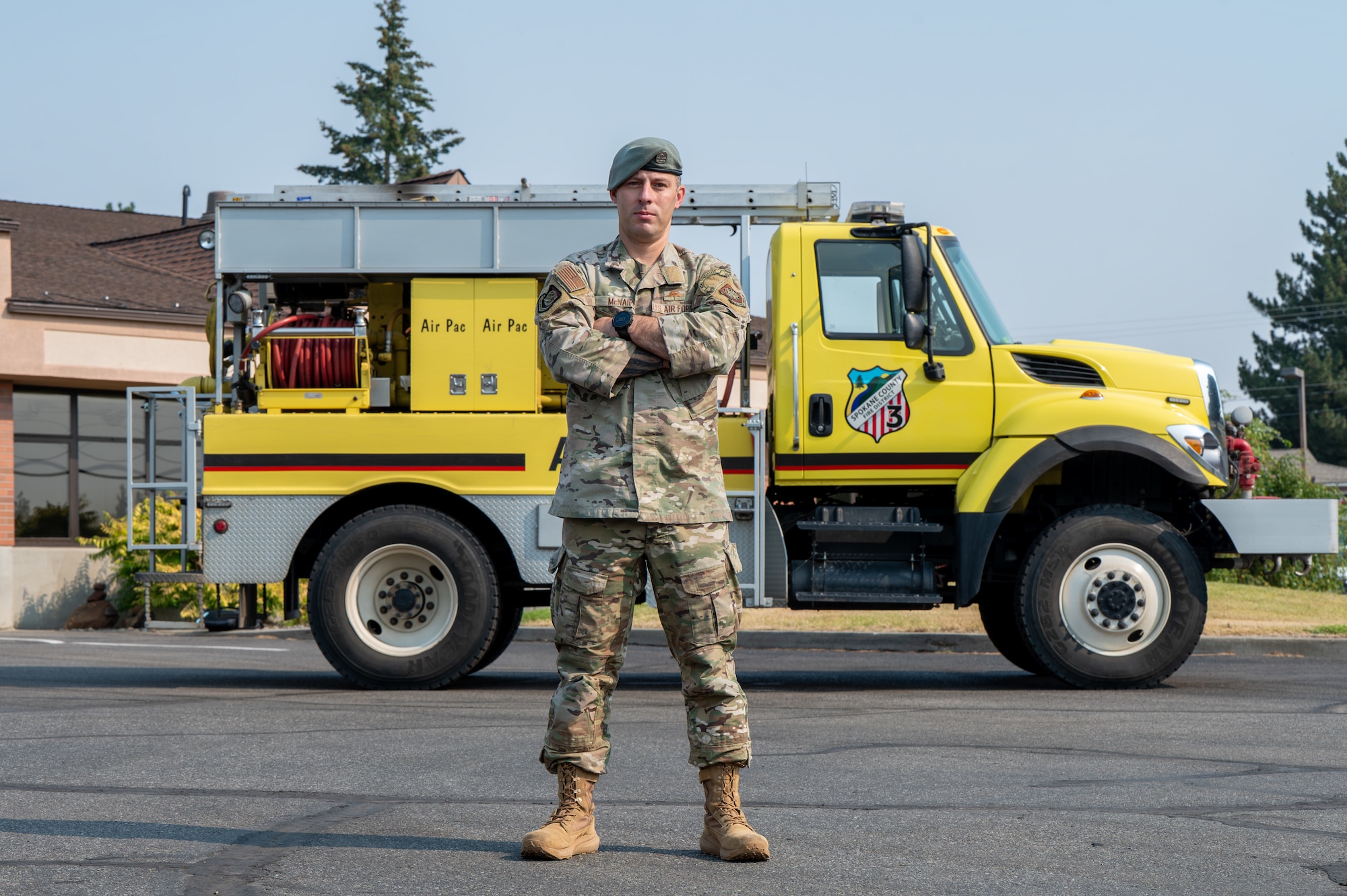 U.S. Air Force Master Sgt. Eric McNair, 92nd Operations Group first sergeant, stands in front of an attack fire apparatus for an environmental portrait at Spokane County Fire District #3, Cheney, Washington, Aug 5., 2026. Responding to emergencies as a volunteer firefighter helps protect the local community while demonstrating the commitment to service that supports military readiness. (U.S. Air Force photo by Airman Audie Curtis)