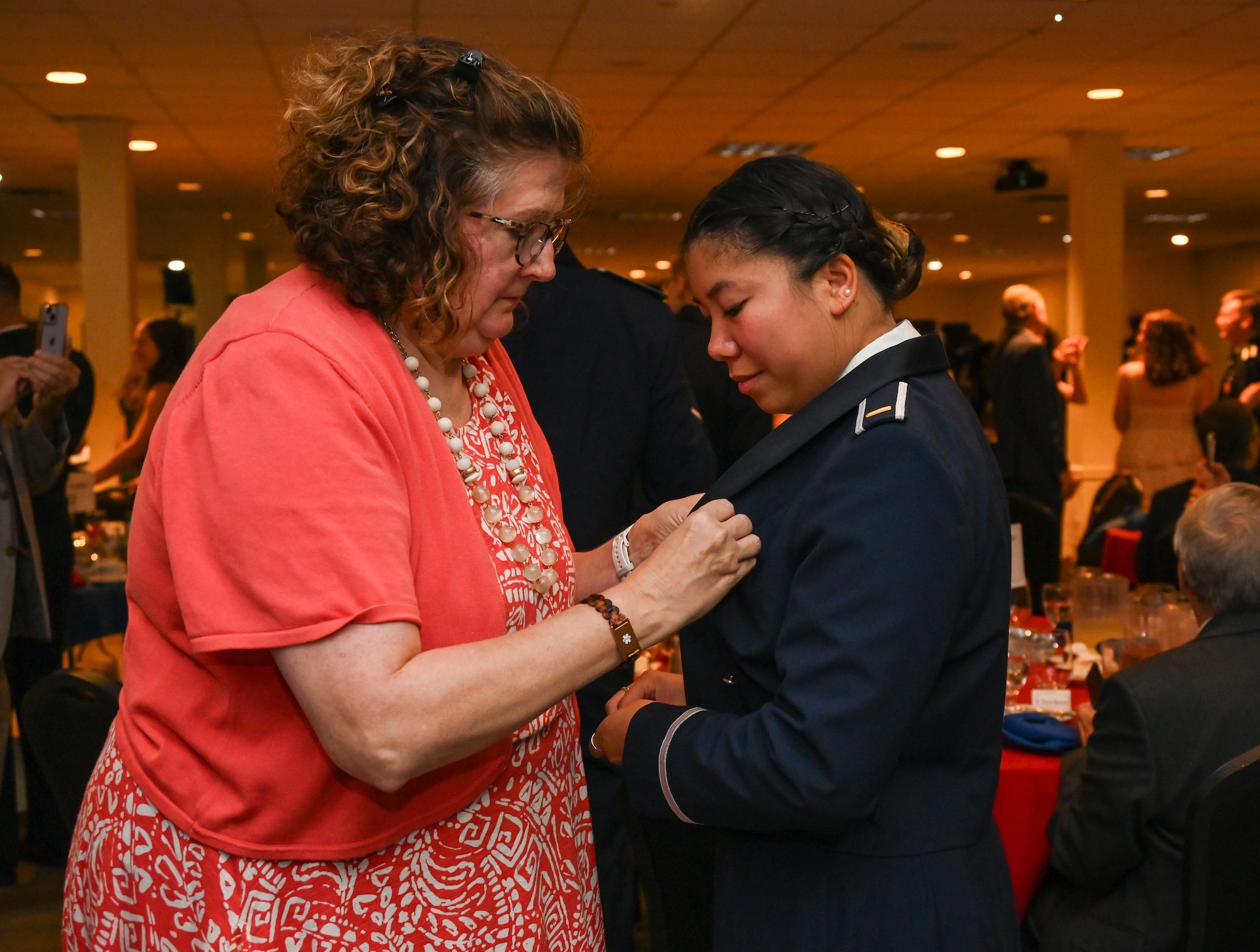 A loved one pins the silver wings onto U.S. Air Force 2nd Lt. Madeline McDonald, 47th Student Squadron student pilot, during the graduation ceremony of Class 26-15 at Laughlin Air Force Base, Texas, Aug 6, 2026. Twenty-three U.S. Air Force officers were awarded silver wings, officially earning the aeronautical rating of pilot. (U.S. Air Force photo by Airman 1st Class Kylie Rabb)