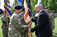 U.S. Army Col. Clay Huffman, left, U.S. Army Support Activity Fort Dix incoming commander, receives the USASA Fort Dix colors from Patrick J. Appelman, right, Installation Management Command - Western Hemisphere director, during the USASA Fort Dix change of command ceremony at Joint Base McGuire-Dix-Lakehurst, N.J., July 29, 2026. Appelman served as the reviewing official for the ceremony, during which, Huffman assumed command of USASA Fort Dix from U.S. Army Col. Bryan Dunker. (U.S. Air Force photo by Kris Patterson)