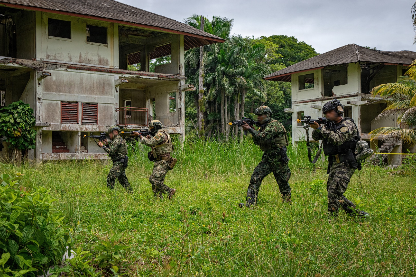 Members of the Policía Nacional de Panamá, Colombia's Military, and the Ecuadorian Marine Corps advance to assault a simulated objective