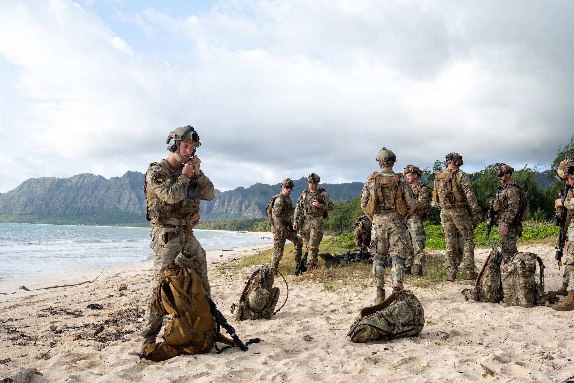 Members of the 140th Security Forces Squadron prepare for Operation Iron Flag, a hands-on, combat simulation field exercise June 17, 2026, at Bellows Air Force Station, Hawaii. The 140th SFS implemented jungle warfare movements, land navigation and nonverbal signals as part of their annual training. (U.S. Air National Guard photo by Senior Airman Eliana Raspet)