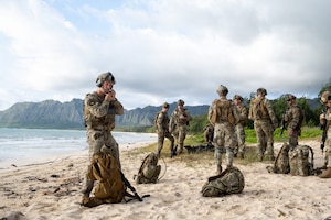 Members of the 140th Security Forces Squadron prepare for Operation Iron Flag, a hands-on, combat simulation field exercise June 17, 2026, at Bellows Air Force Station, Hawaii. The 140th SFS implemented jungle warfare movements, land navigation and nonverbal signals as part of their annual training. (U.S. Air National Guard photo by Senior Airman Eliana Raspet)