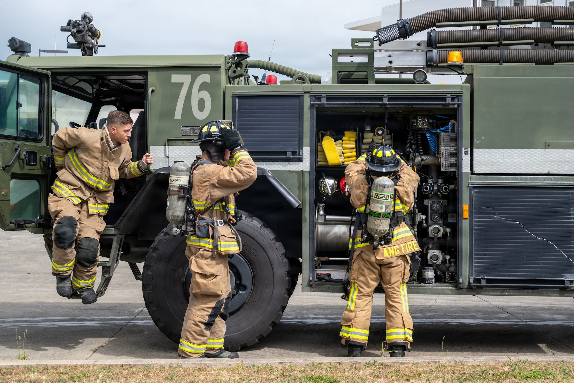 Firefighters with the 140th Civil Engineer Squadron and U.S. Marine Corps firefighters arrive on scene during a structural firefighting tactics exercise, June 15, 2026, at Marine Corps Air Station Kaneohe Bay, Hawaii. The joint training with the Marine Corps built interservice relations and facilitated the exchange of tactical expertise. (U.S. Air National Guard photo by Senior Airman Eliana Raspet)