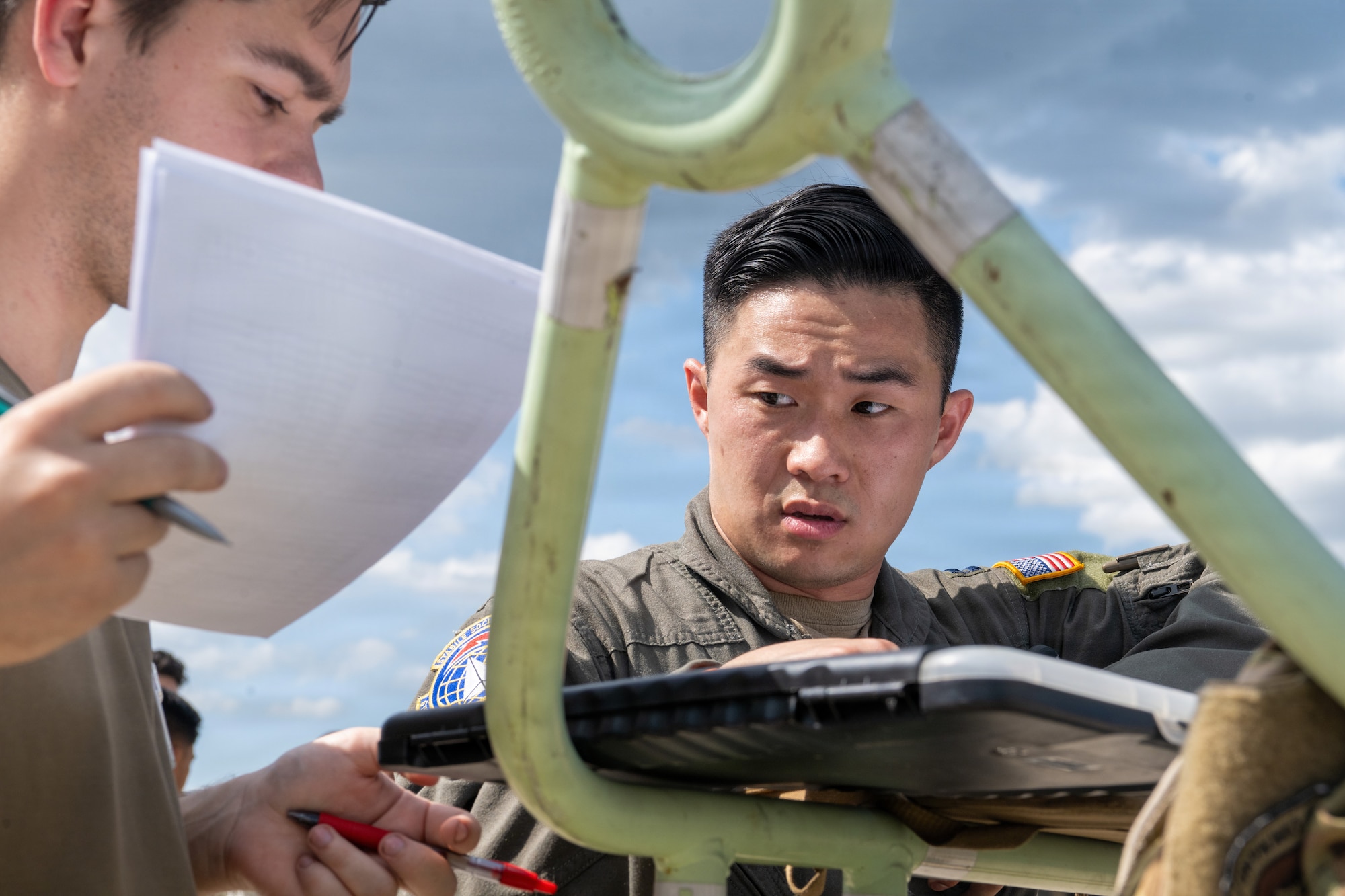 U.S. Air Force Capt. Garrick Yokoe, 91st Expeditionary Air Refueling Squadron pilot, reviews an aircraft maintenance log during a redeployment at Macdill Air Force Base, Florida, July 2, 2026. Aircrew reviewed aircraft documentation during post-flight procedures on a KC-135 Stratotanker following its arrival as part of redeployment operations supporting the safe return of deployed Airmen. (U.S. Air Force photo by Airman Micquill Davis)