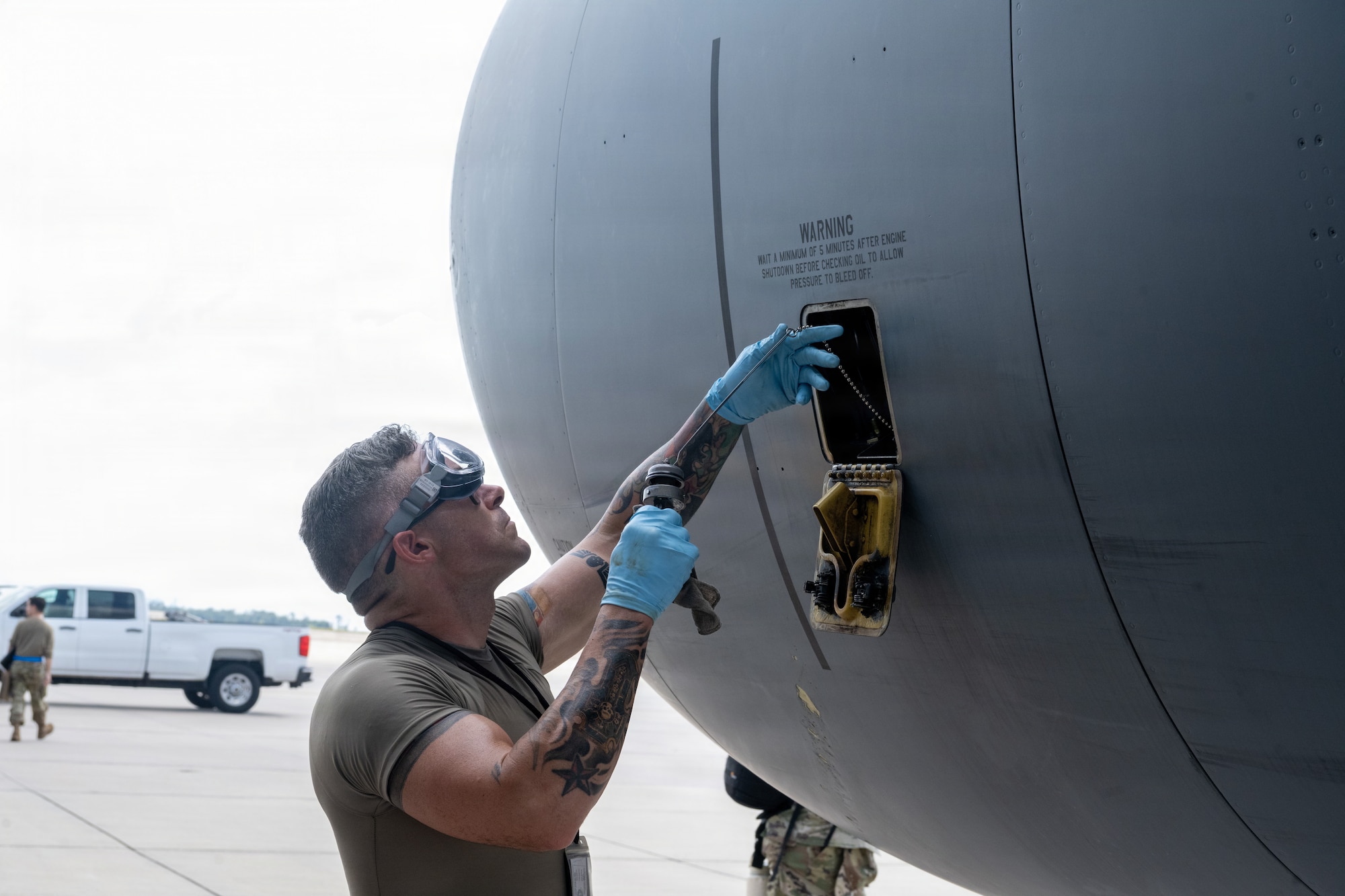 U.S. Air Force Airman 1st class James Baggett, 6th Aircraft Maintenance Squadron crew chief, inspects the oil level on a KC-135 Stratotanker during a redeployment at MacDill Air Force Base, Florida, July 2, 2026. Airmen from the 6th AMXS conducted post-flight inspections as part of redeployment operations supporting the safe return of deployed Airmen. (U.S. Air Force photo by Airman Micquill Davis)
