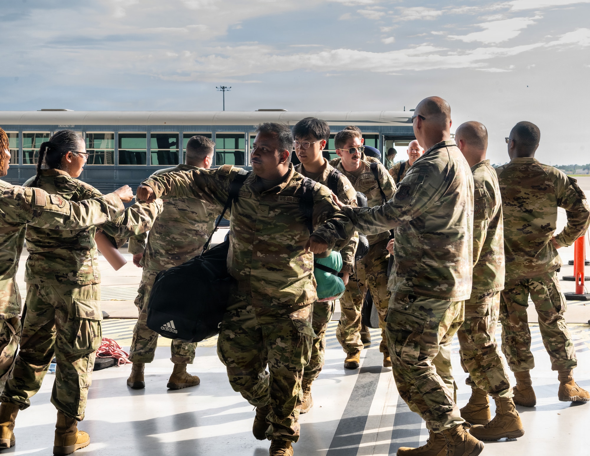 Returning Airmen are welcomed by friends and family during a redeployment at MacDill Air Force Base, Florida, July 2, 2026. The welcome home event celebrated the successful completion of the deployment and bonds shared among Airmen. (U.S. Air Force photo by Airman Micquill Davis)