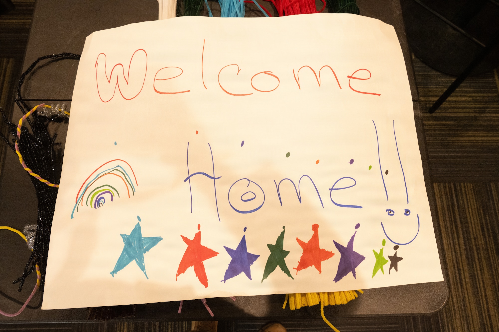 A handmade sign is displayed before a redeployment at MacDill Air Force Base, Florida, July 2, 2026. Family and friends created personalized signs to celebrate the return of their loved ones from deployment. (U.S. Air Force photo by Airman Micquill Davis)