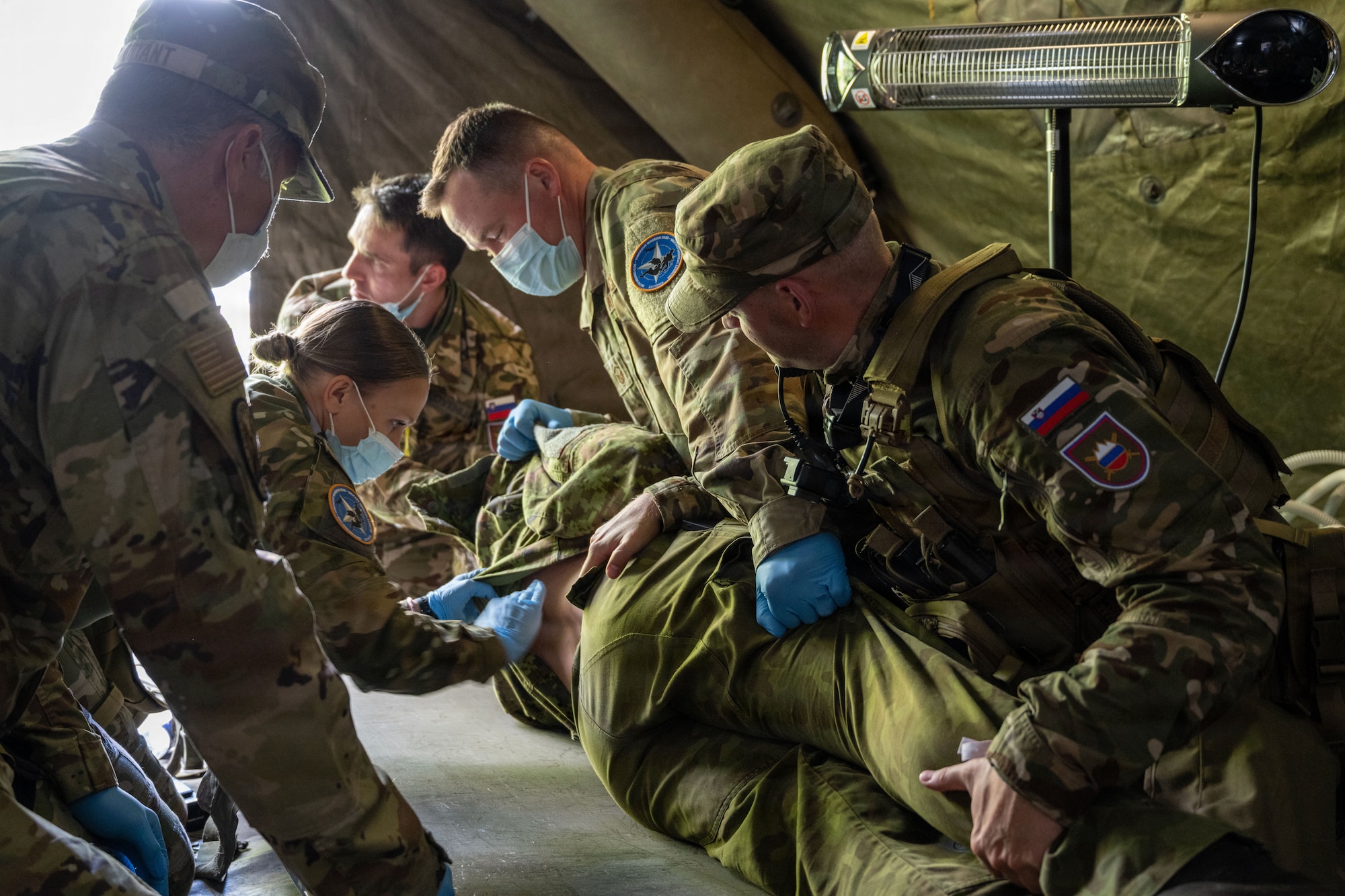 Medical personnel from the Colorado National Guard’s CERFP (Chemical, Biological, Radiological, Nuclear, and high-yield Explosive Enhanced Response Force Package) provide simulated medical treatment alongside their counterparts from the Slovenian Medical Forces at the Vigorous Warrior exercise, Tapa, Estonia June 16, 2026. Vigorous Warrior is NATO’s multinational medical exercise that trains military medical support with a strong focus on interoperability, medical readiness and cooperation between civilian and military medical systems. (U.S. Air National Guard photo by 2nd Lt. Stephanie Zimmerman)