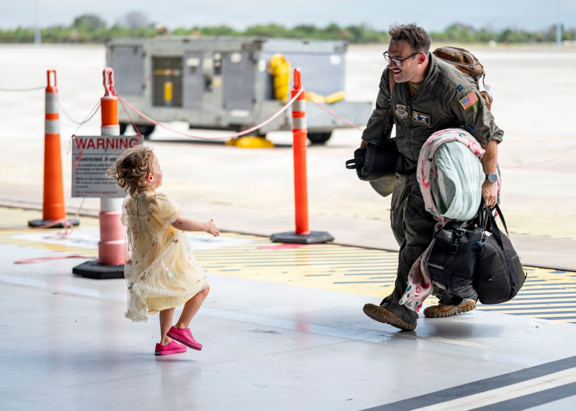 U.S. Air Force Capt. Wyatt Bertrand, 91st  Air Refueling Squadron pilot, reunites with his daughter following a deployment at MacDill Air Force Base, Florida, July 3, 2026. Military families provide the foundation that enables the 6th Air Refueling Wing to generate combat-ready Airmen and project airpower across the globe. (U.S. Air Force photo by Senior Airman Monique Stober)