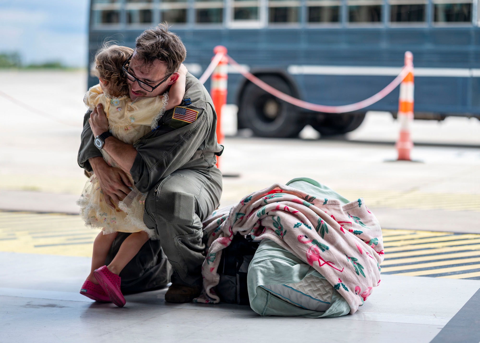 U.S. Air Force Capt. Wyatt Bertrand, 91st Air Refueling Squadron pilot, embraces his daughter during a redeployment at MacDill Air Force Base, Florida, July 3, 2026. Homecomings like these highlight the resilience and unwavering support of military families, whose sacrifices help sustain the 6th Air Refueling Wing's global mission. (U.S. Air Force photo by Senior Airman Monique Stober)