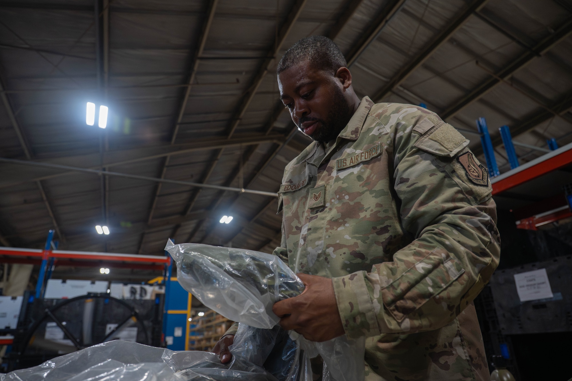 U.S. Air Force Staff Sgt. Caron Edouard, 8th Logistics Readiness Squadron individual protective equipment supervisor, inspects IPE to ensure it is suitable to be issued to personnel at Kunsan Air Base, Republic of Korea, Aug. 3, 2026. Airmen assigned to the 8th LRS IPE flight inspect equipment, verify hand receipts and process military personnel to ensure preparedness and accountability for all members stationed with the Wolf Pack. (U.S. Air Force photo by Staff Sgt. Cedrique Oldaker)