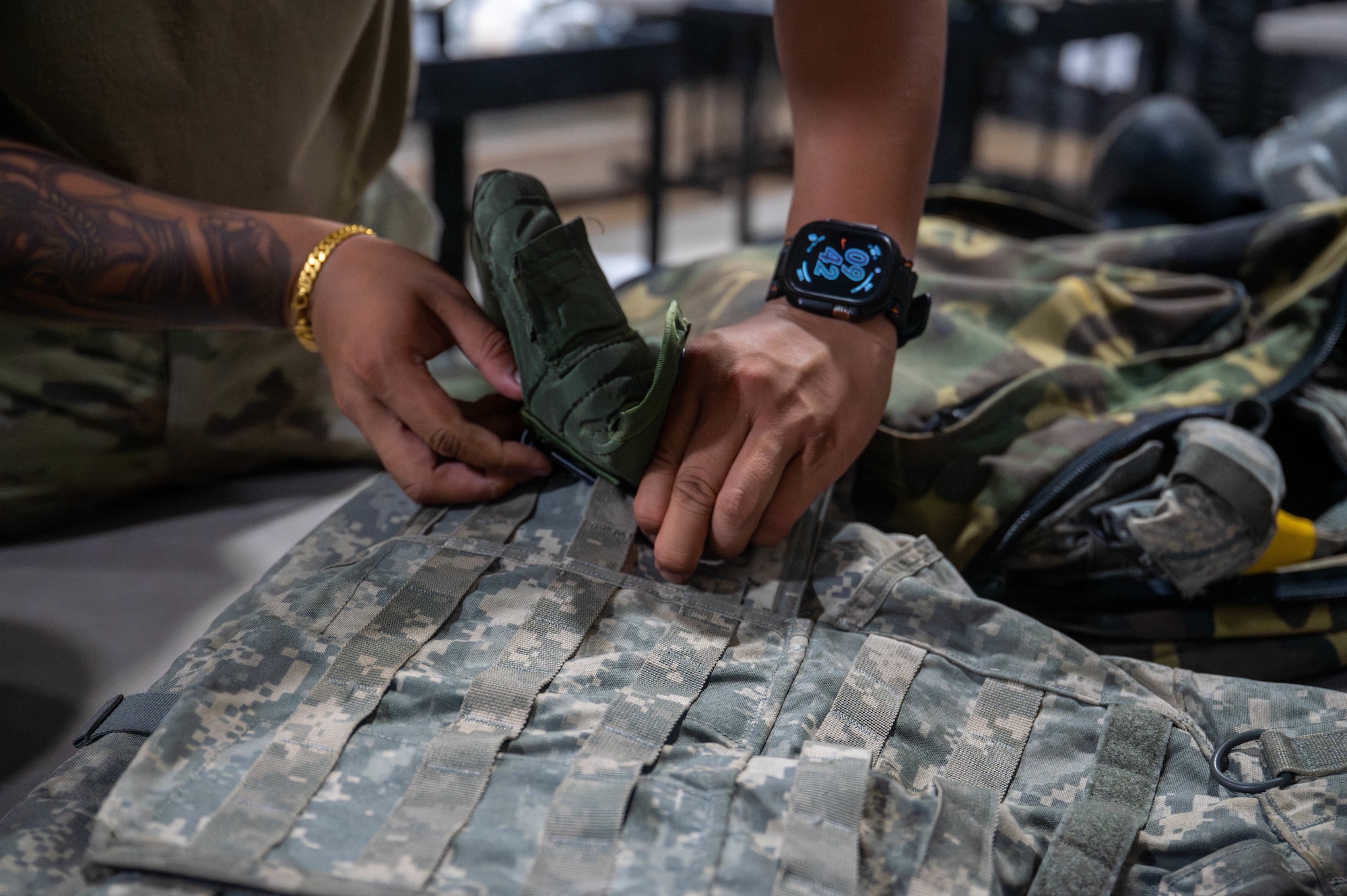 A U.S. Air Force Airman assigned to the 8th Logistics Readiness Squadron removes training gear from a set of training individual protective equipment to outprocess an Airman at Kunsan Air Base, Republic of Korea, Aug. 3, 2026. The 8th LRS IPE flight plays a critical role in maintaining and distributing essential gear, ensuring Airmen are equipped for both training exercises and real-world missions in the pacific region. (U.S. Air Force photo by Staff Sgt. Cedrique Oldaker)