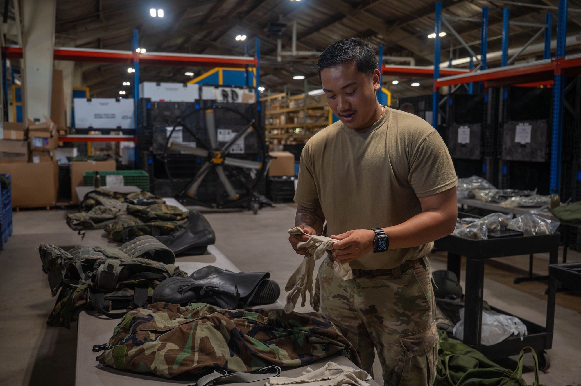 U.S. Air Force Senior Airman Nathan Saldua, 8th Logistics Readiness Squadron individual protective equipment journeyman, inspects returned training IPE at Kunsan Air Base, Republic of Korea, Aug. 3, 2026. The 8th LRS IPE flight plays a critical role in maintaining and distributing essential gear, ensuring Airmen are equipped for both training exercises and real-world missions in the Pacific region. (U.S. Air Force photo by Staff Sgt. Cedrique Oldaker)