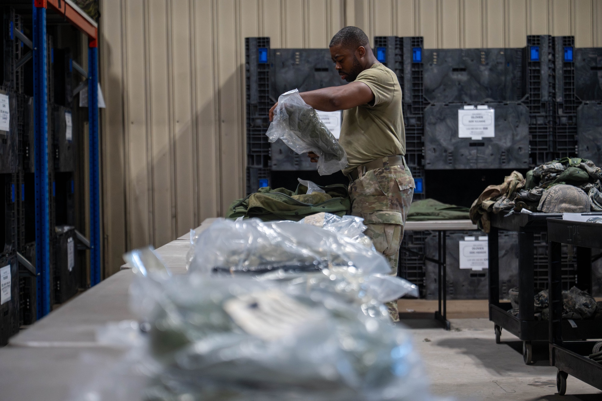 U.S. Air Force Staff Sgt. Caron Edouard, 8th Logistics Readiness Squadron individual protective equipment supervisor, inspects IPE to ensure it is suitable to be issued to personnel at Kunsan Air Base, Republic of Korea, Aug. 3, 2026. The 8th LRS IPE flight is responsible for ensuring in-processing personnel receive mobility gear such as chemical suits and gas masks. (U.S. Air Force photo by Staff Sgt. Cedrique Oldaker)