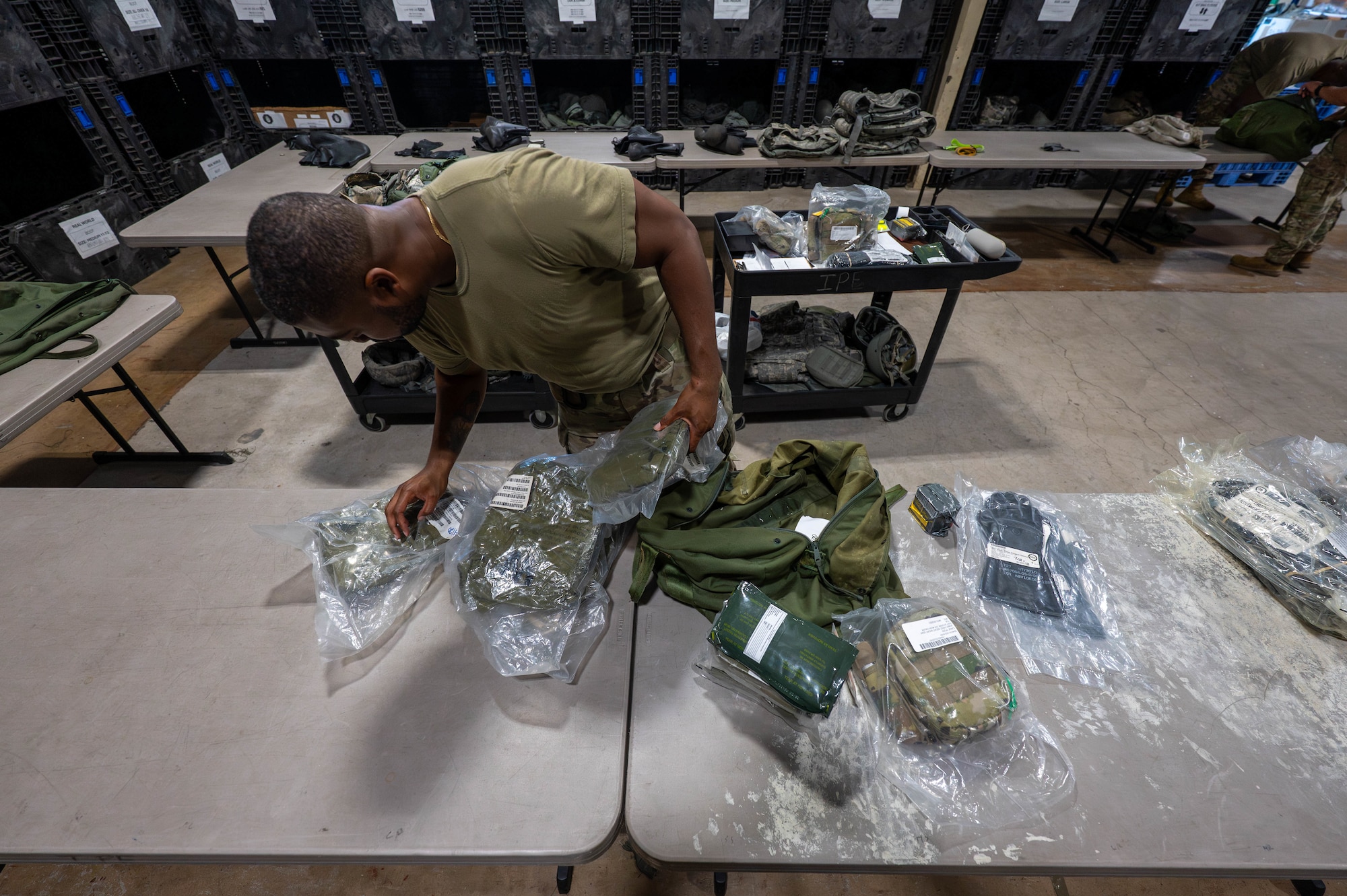 U.S. Air Force Staff Sgt. Caron Edouard, 8th Logistics Readiness Squadron individual protective equipment supervisor, inspects IPE to ensure it is suitable to be issued to members at Kunsan Air Base, Republic of Korea, Aug. 3, 2026. Airmen assigned to the 8th LRS IPE flight provide combat-ready support and ensure operational readiness by maintaining and issuing protective gear to the Wolf Pack. (U.S. Air Force photo by Staff Sgt. Cedrique Oldaker)