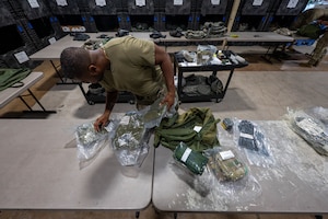 U.S. Air Force Staff Sgt. Caron Edouard, 8th Logistics Readiness Squadron individual protective equipment supervisor, inspects IPE to ensure it is suitable to be issued to members at Kunsan Air Base, Republic of Korea, Aug. 3, 2026. Airmen assigned to the 8th LRS IPE flight provide combat-ready support and ensure operational readiness by maintaining and issuing protective gear to the Wolf Pack. (U.S. Air Force photo by Staff Sgt. Cedrique Oldaker)