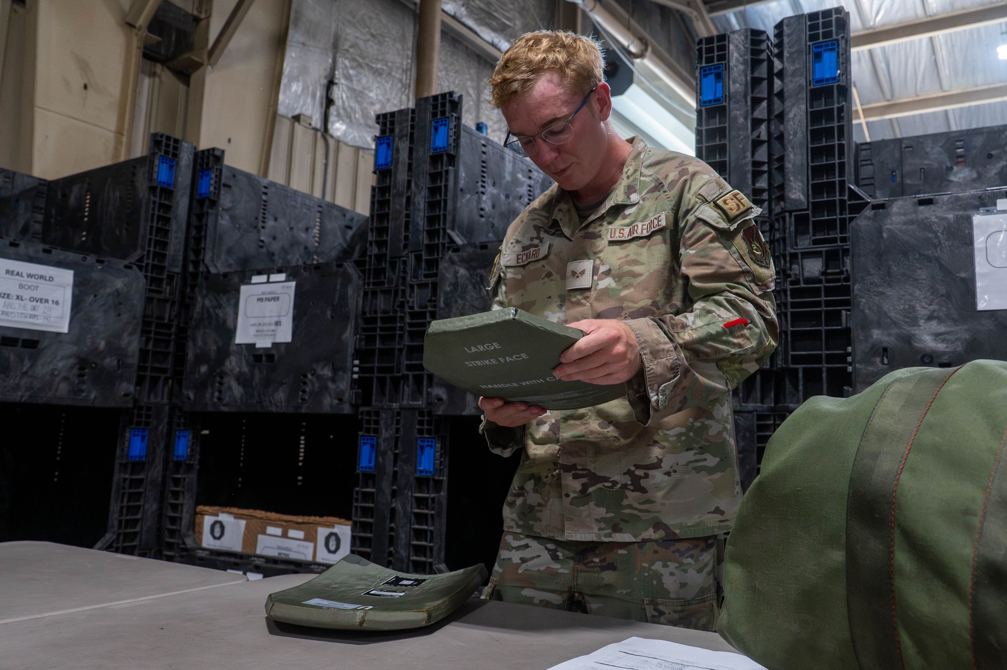 U.S. Air Force Senior Airman Dylan Eckard, 8th Security Forces Squadron patrolman, inspects protective ballistic vest plates at Kunsan Air Base, Republic of Korea, Aug. 3, 2026. The 8th Logistics Readiness Squadron’s individual protective equipment flight is responsible for ensuring in-processing personnel receive mobility gear such as chemical suits, gas masks, and ballistic protection plates and vests for use in training exercises and real-world missions (U.S. Air Force photo by Staff Sgt. Cedrique Oldaker)