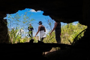 U.S. Air Force Airmen assigned to the 374th Airlift Wing exit from the location of a mounted machine gun