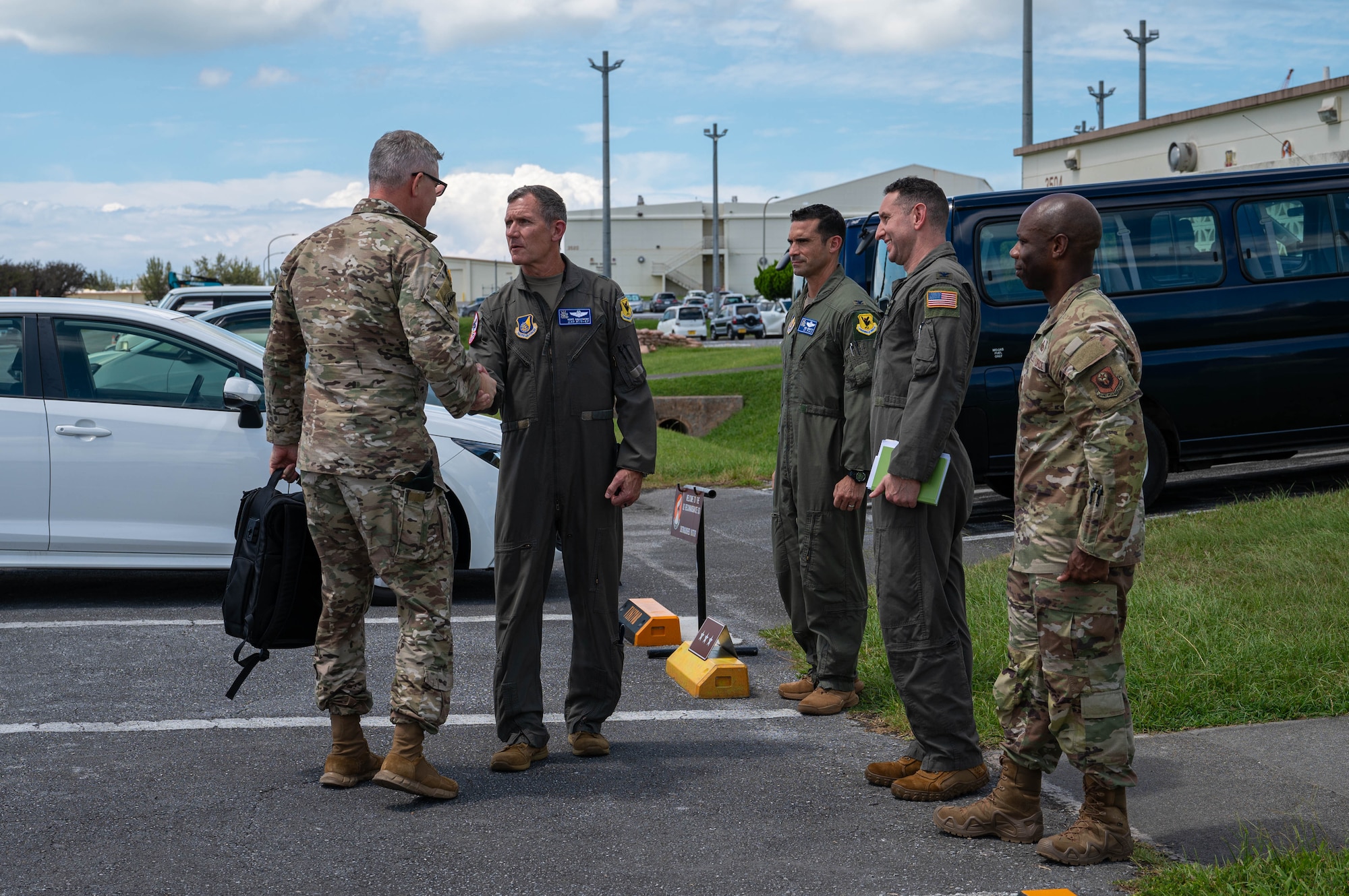 U.S. Air Force Brig. Gen. John Gallemore, 18th Wing commander, center left, greets U.S. Army Lt. Gen. Steven Marks, left, vice commander of U.S. Special Operations Command and director of the Defense Autonomous Warfare Group at the 82d Reconnaissance Squadron at Kadena Air Base, Japan, July 23, 2026. Marks visited Kadena to engage with 18th Wing leadership, discuss DAWG initiatives and observe the installation's operational capabilities. (U.S. Air Force photo by Airman 1st Class Nathaniel Jackson)
