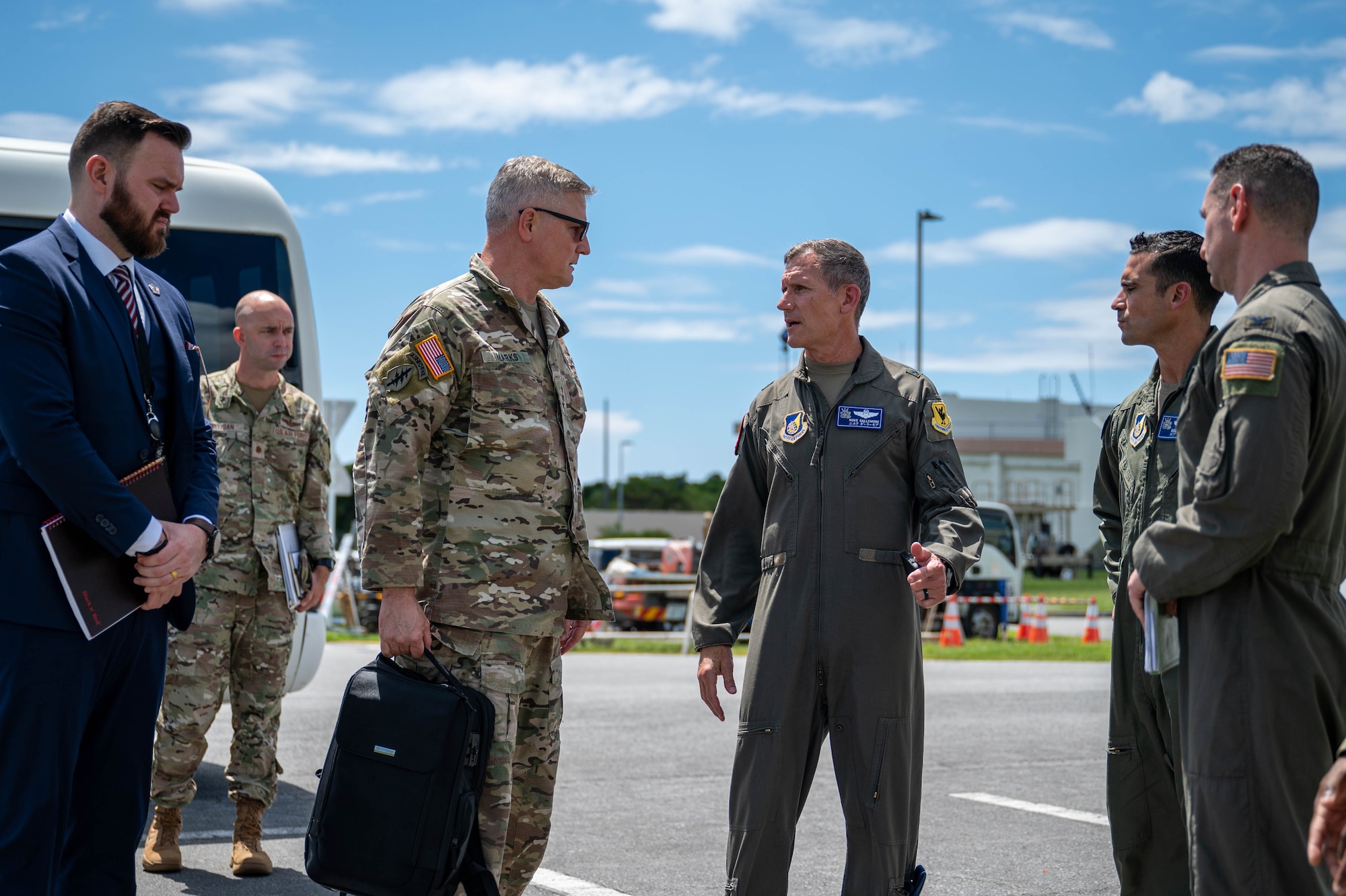 U.S. Air Force Brig. Gen. John Gallemore, middle right, 18th Wing commander, speaks with U.S. Army Lt. Gen. Steven Marks, vice commander of U.S. Special Operations Command and director of the Defense Autonomous Warfare Group at the 82d Reconnaissance Squadron at Kadena Air Base, Japan, July 23, 2026. The visit included a helicopter tour of the installation and a visit to the 18th Munitions Squadron to observe the wing's mission and capabilities. (U.S. Air Force photo by Airman 1st Class Nathaniel Jackson)