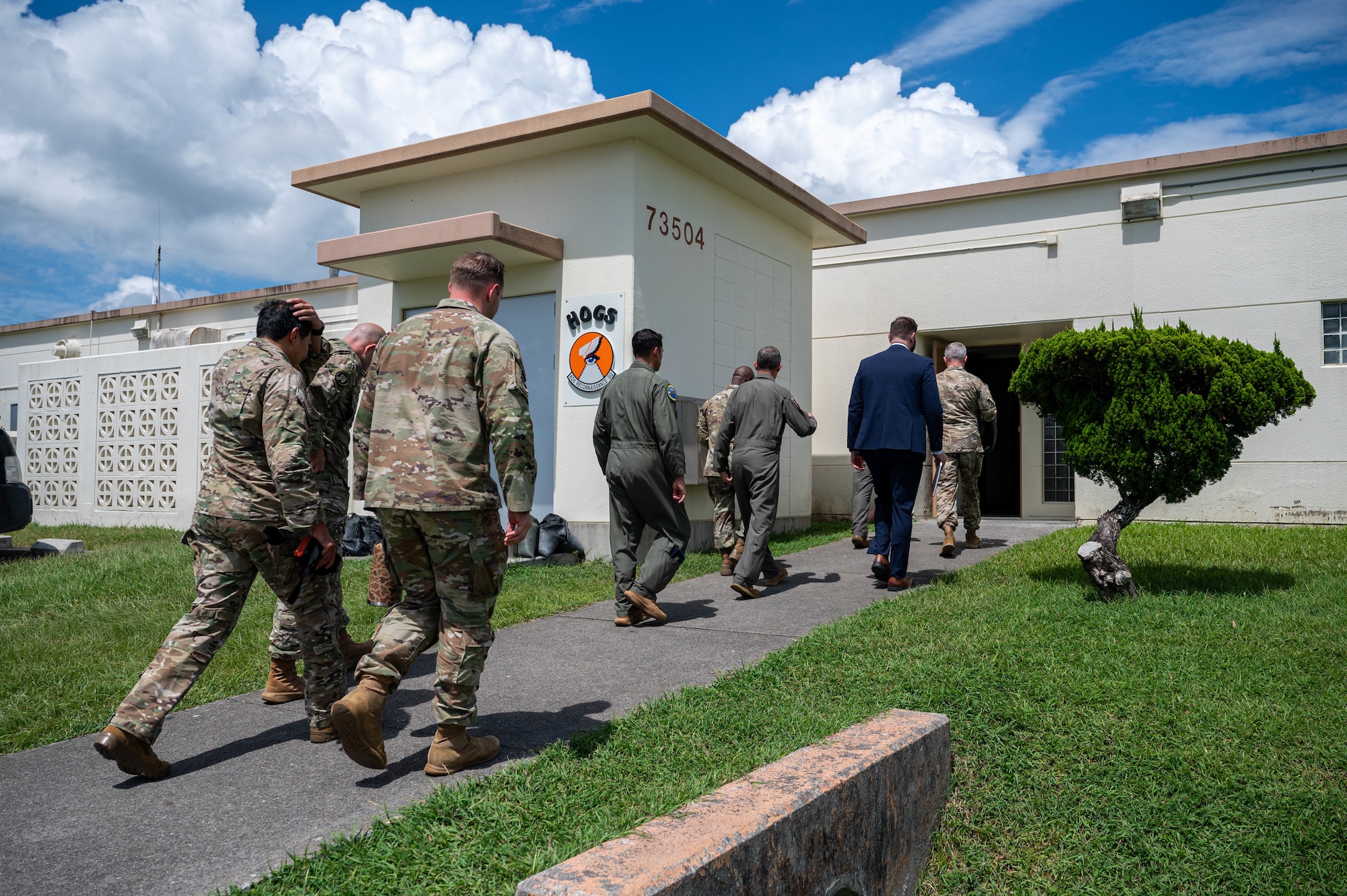 U.S. Air Force Brig. Gen. John Gallemore, 18th Wing commander, leads U.S. Army Lt. Gen. Steven Marks, vice commander of U.S. Special Operations Command and director of the Defense Autonomous Warfare Group and other Airmen into the 82d Reconnaissance Squadron at Kadena Air Base, Japan, July 23, 2026. During the visit, Marks conducted site surveys of potential asset storage locations and met with Airmen supporting the 18th Wing’s mission. (U.S. Air Force photo by Airman 1st Class Nathaniel Jackson)