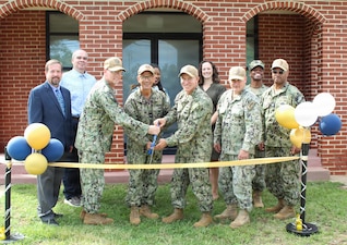 A multi-agency team of military leaders, facilities planners, and administrative staff stand together for a group photo during the ribbon-cutting ceremony for Building 320 at Naval Support Facility Indian Head, Aug. 4. The ceremony marked the completion of a collaborative $1.06 million joint investment between CNIC, Navy Medicine, NAVFAC, and the U.S. Army Corps of Engineers to establish a state-of-the-art Industrial Hygiene facility designed to support occupational safety in high-risk energetics environments.

Pictured from left to right are: Paul McComb; Marcus Ramirez; Cmdr. Benjamen Hall; Rear Adm. Robert Hawkins, commander, Naval Medical Forces Atlantic (NMFL); Shanda Drummer; Capt. Ken Radford, commanding officer, Navy Medicine Readiness and Training Command (NMRTC) Patuxent River; Danielle Del Rosario; Cmdr. Robert Lusk, executive officer of Naval Support Activity South Potomac; Lt. Larenzo Lott; and Capt. Dario Morgan.