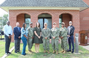 Staff and planning personnel from the Bureau of Medicine and Surgery (BUMED) and Naval Medical Forces Atlantic (NMFL) gather outside Building 320 for the ribbon-cutting on Naval Support Facility Indian Head, Aug. 4. Facilities and environment planners from across Navy Medicine collaborated extensively with base commands, managing logistics, funding coordination, and IT integration to successfully execute the $1.06 million renovation project.

Pictured from left to right are: Daniel Bosso; Shanda Drummer; Lt. Larenzo Lott; Danielle Del Rosario; Rear Adm. Robert Hawkins; Capt. Ken Radford; Capt. Dario Morgan; and Brian Grace.