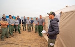 Giovanni Carranza, a crew boss with the California Smokejumpers, briefs Oregon Air National Guard hand crew members on their assignment for the day using a fire map at the Grasshopper Fire camp near Tygh Valley, Oregon, Aug. 9, 2026.
Photo by Maj. W. Chris Clyne.