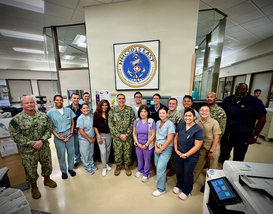 SAN DIEGO (Aug. 6, 2026) – Acting Surgeon General and Chief, U.S. Navy Bureau of Medicine and Surgery, Rear Adm. Matthew Case (center) poses for a group photo with nursing staff in Naval Medical Center San Diego's (NMCSD) 5 East medical ward. Case toured the ward to meet directly with deckplate medical professionals and recognize outstanding Sailors executing Navy Medicine's strategic readiness priorities. (U.S. Navy photo by Contributed)