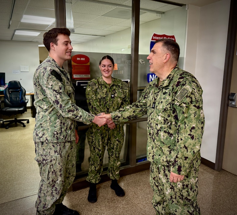 SAN DIEGO (Aug. 6, 2026) – Acting Surgeon General and Chief, U.S. Navy Bureau of Medicine and Surgery, Rear Adm. Matthew Case (right) presents a command coin to Hospital Corpsman 3rd Class Alexander Barnes in the 5 North medical ward at Naval Medical Center San Diego (NMCSD). Case toured the ward to meet directly with staff and recognize outstanding Sailors for their immeasurable dedication to patient care and Navy Medicine's mission. (U.S. Navy photo by Contributed)