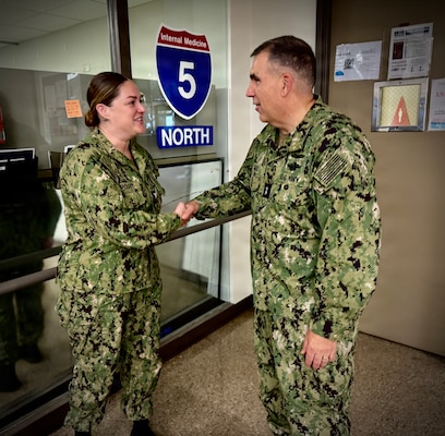 SAN DIEGO (Aug. 6, 2026) – Acting Surgeon General and Chief, U.S. Navy Bureau of Medicine and Surgery, Rear Adm. Matthew Case (right) presents a command coin to Hospital Corpsman 3rd Class Kaitlyn Crosby in the 5 North medical ward at Naval Medical Center San Diego (NMCSD). Case toured the ward to meet directly with staff and recognize outstanding Sailors for their immeasurable dedication to patient care and Navy Medicine's mission. (U.S. Navy photo by Contributed)