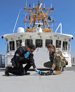 A U.S. Coast Guard boarding team member and an Oregon Air National Guardsman assigned to the Oregon National Guard's 102nd Civil Support Team use specialized equipment to search for a simulated radiological source aboard the Coast Guard Cutter David Duren during joint training in Astoria, Oregon, Aug. 5, 2026.