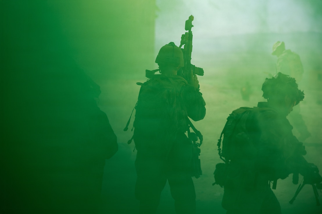 U.S. Marines with Echo Company, 2nd Battalion, 1st Marine Regiment, 1st Marine Division, maneuver through a smoke grenade during a company attack as a part of Adversary Force Exercise 4-26 at Marine Corps Air-Ground Combat Center Twentynine Palms, California, July 30, 2026. AFX serves as an opportunity for units to receive training and certification across multiple warfighting functions in realistic force-on-force scenarios. (U.S. Marine Corps photo by Sgt. Vincent Needham)