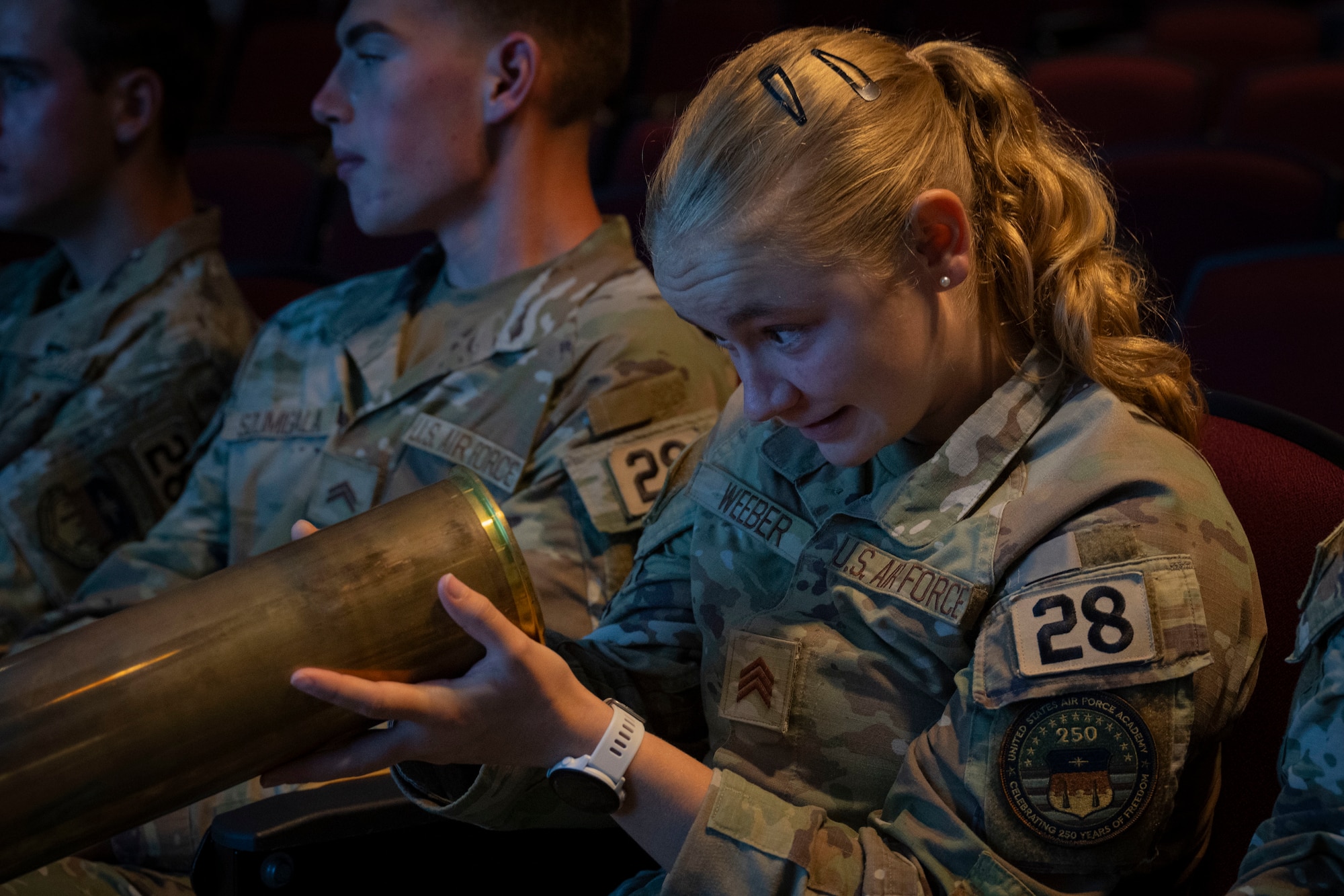 a U.S. Air Force Academy cadet, holds a 105 mm shell during an immersion at Hurlburt Field