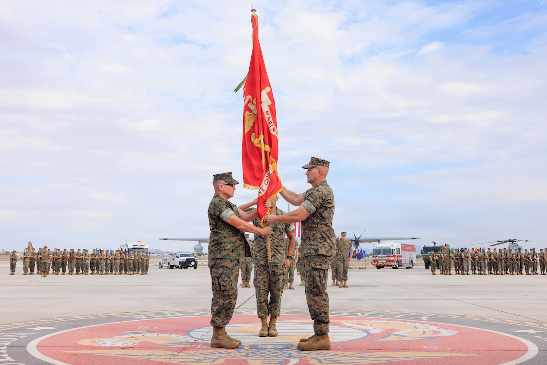 U.S. Marine Corps Col. David J. Bennett, left, incoming commanding officer, Marine Corps Air Station Yuma, receives the colors from Col. Jared K. Stone, outgoing commanding officer, MCAS Yuma, during the MCAS Yuma change of command ceremony at MCAS Yuma, Arizona, July 17, 2026. The change of command ceremony formally recognizes the transfer of authority and responsibility from Col. Jared K. Stone to Col. David J. Bennett. (U.S. Marine Corps photo by Lance Cpl. Sarah E. Foster)
