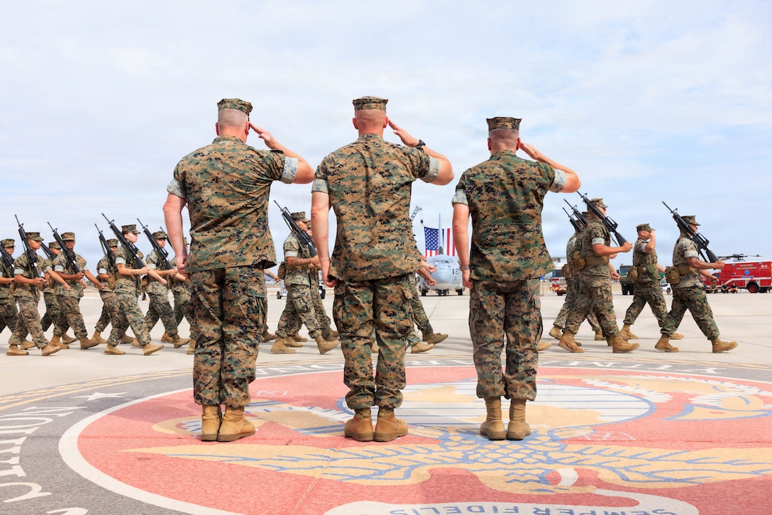 U.S. Marine Corps Col. Charles E. Dudik, left, deputy commander, Marine Corps Installations West, Marine Corps Base Camp Pendleton, Col. Jared K. Stone, center, outgoing commanding officer, Marine Corps Air Station Yuma, and Col. David J. Bennett, right, incoming commanding officer, MCAS Yuma, render a salute during pass in review at MCAS Yuma, Arizona, July 17, 2026. The change of command ceremony formally recognizes the transfer of authority and responsibility from Col. Jared K. Stone to Col. David J. Bennett. (U.S. Marine Corps photo by Lance Cpl. Sarah E. Foster)