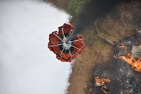 A Washington National Guard helicopter bucket dumps water on the Autumn Lane Fire near Spokane, Washington, August 4, 2026.