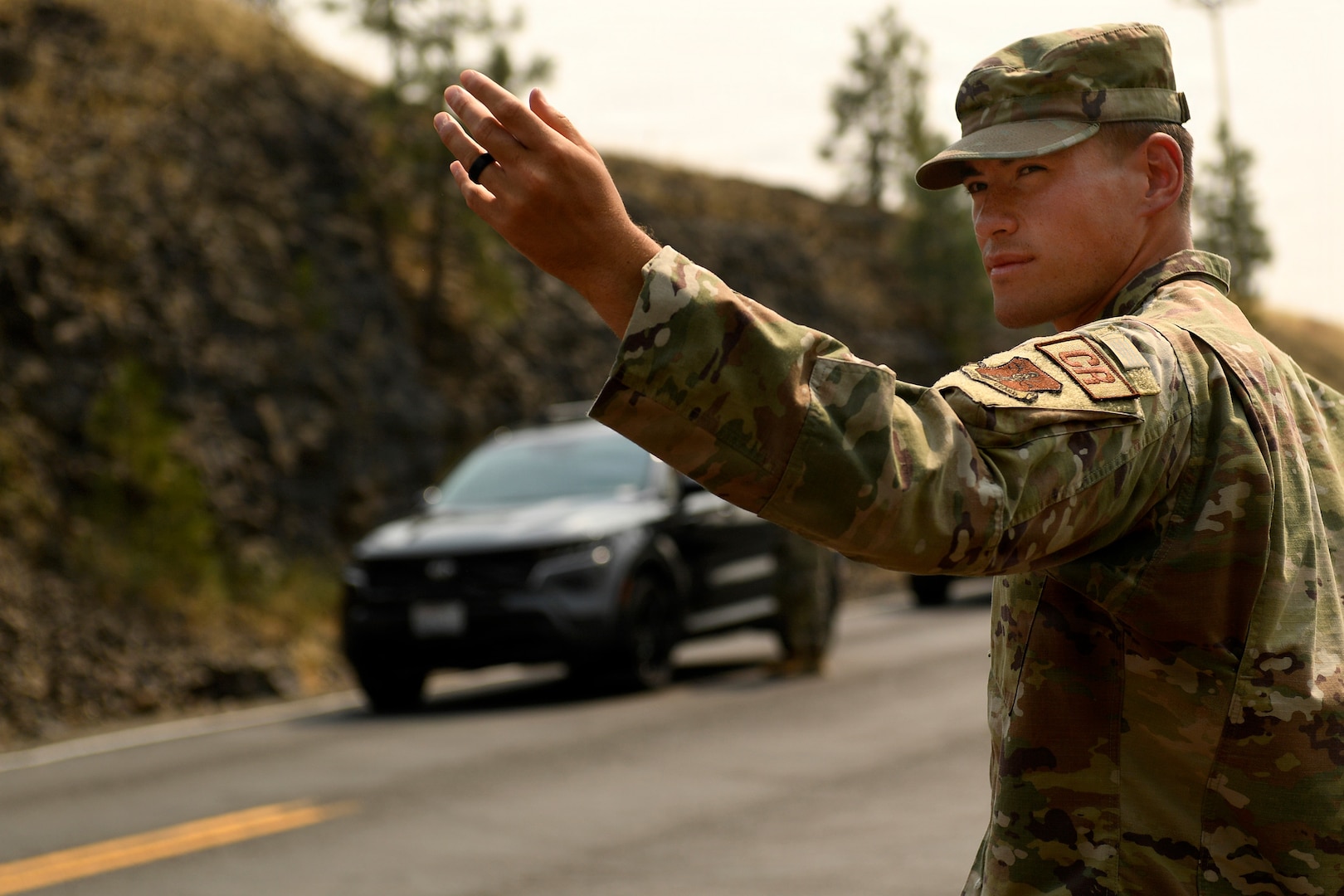 U.S. Air Force Airman Basic Ochirt Caldwell, air transportation specialist with the 111th Contingency Response Squadron, Washington Air National Guard manages a traffic control point near Spokane, Washington, Aug. 7, 2026.