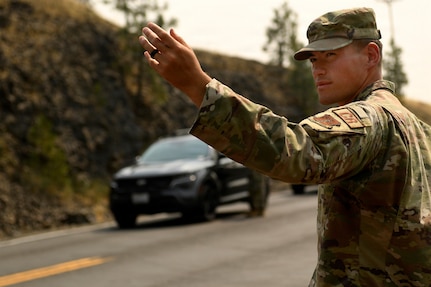 U.S. Air Force Airman Basic Ochirt Caldwell, air transportation specialist with the 111th Contingency Response Squadron, Washington Air National Guard manages a traffic control point near Spokane, Washington, Aug. 7, 2026.