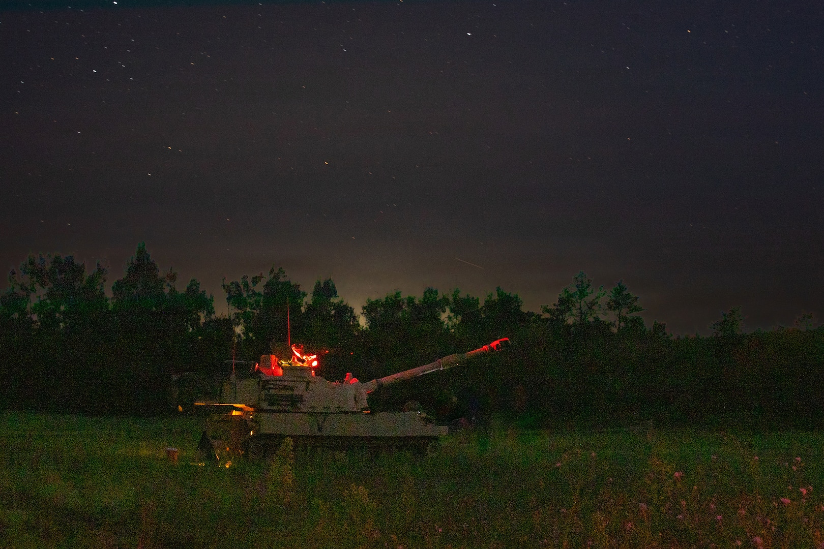 M109A6 Paladins operated by U.S. Army Soldiers assigned to C Battery, 1st Battalion, 201st Field Artillery Regiment, West Virginia Army National Guard, prepare to conduct a nighttime live-fire mission during Exercise Northern Strike 26-2 at the National All-Domain Warfighting Center in Grayling, Michigan, Aug. 6, 2026.
