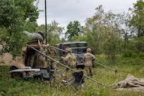 U.S. Army Soldiers assigned to A Battery, 1st Battalion, 201st Field Artillery Regiment, West Virginia Army National Guard, set up an OE-254/GRC ground antenna system in preparation for a fire mission during Exercise Northern Strike 26-2 in Michigan, Aug. 5, 2026.