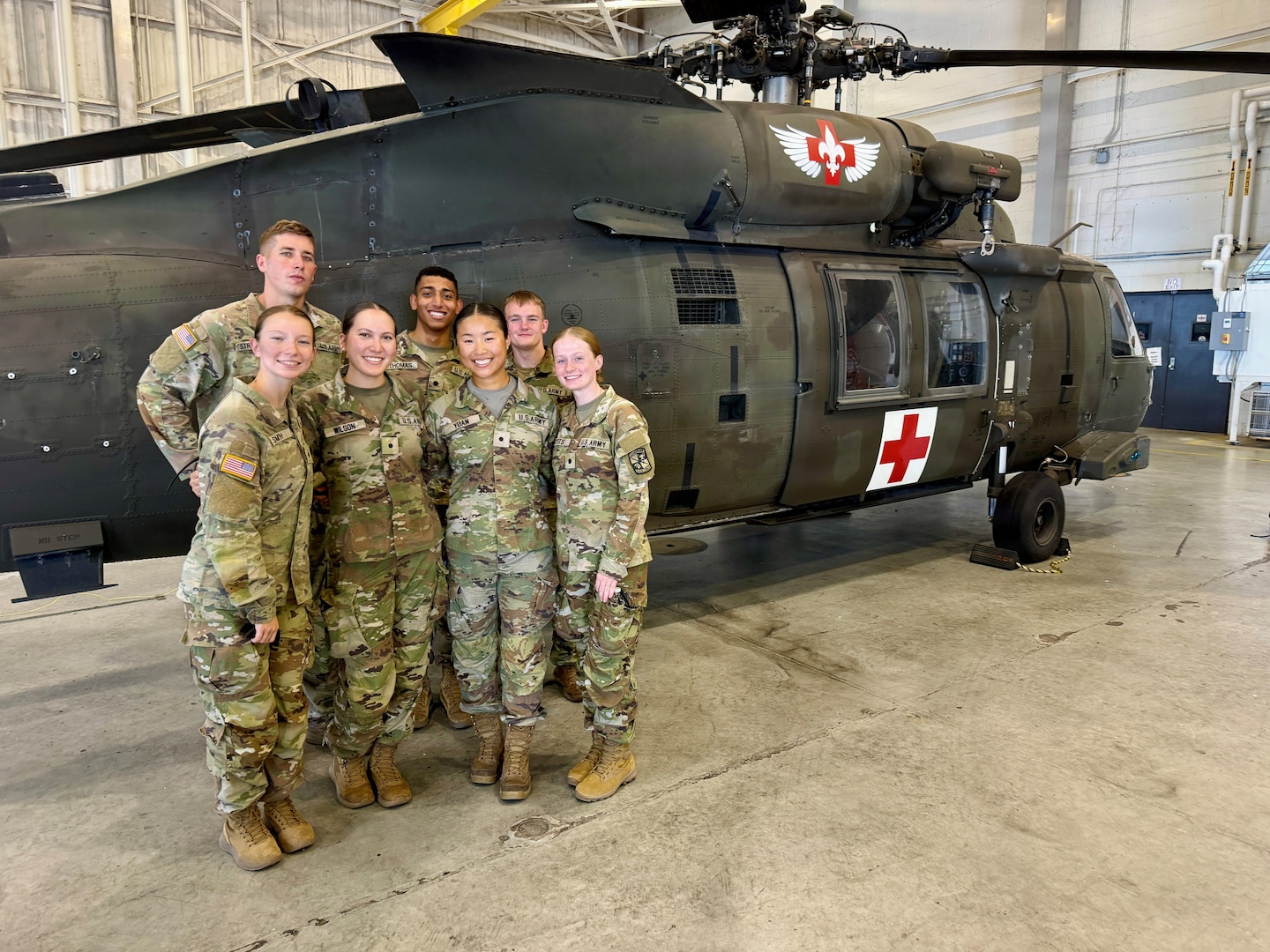Group of Nursing Cadets poses for a group photo in front of a Medevac helicopter.